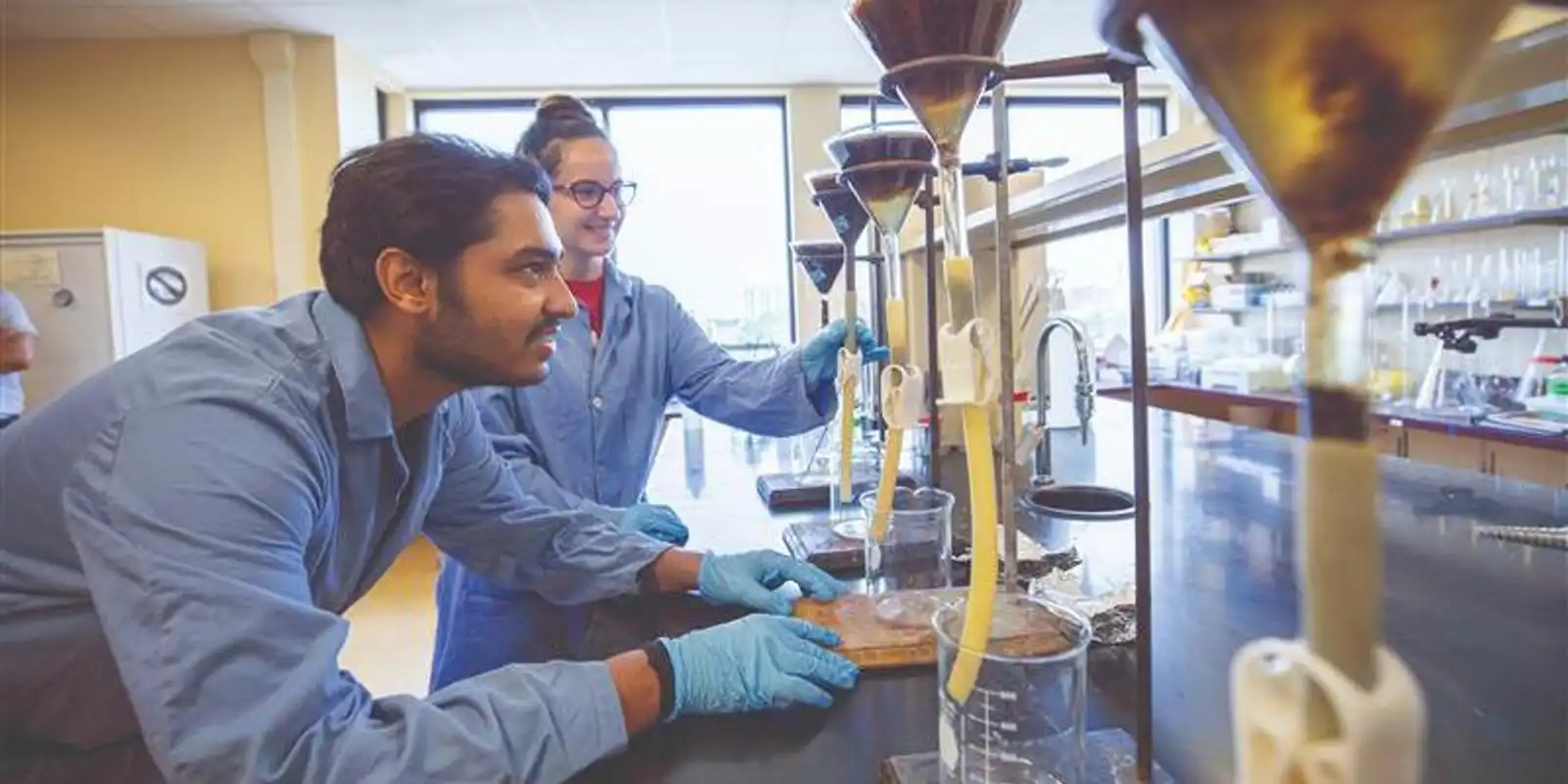 Students working in an environmental engineering lab in Pennsylvania on water filtration as part of an undergraduate environmental engineering degree program.