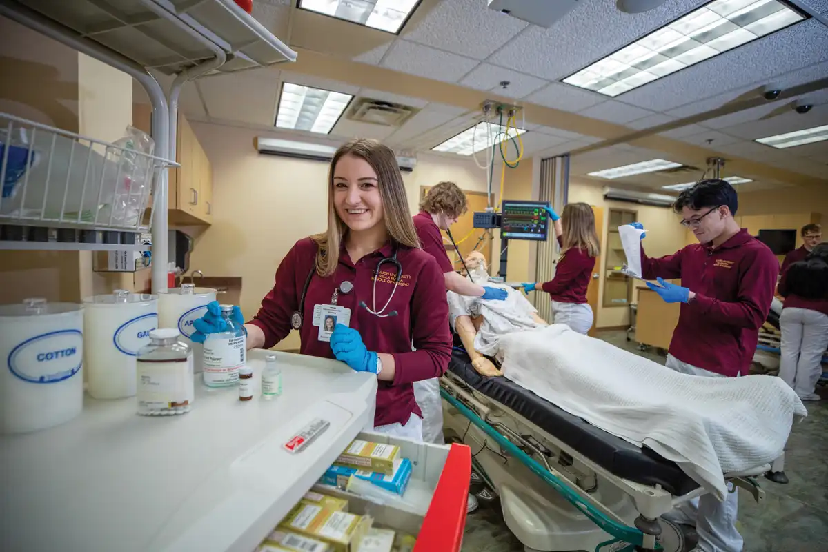Students in a Bachelor of Science in Nursing program practice hands-on patient care in a simulation lab at a nursing school in Erie, PA
