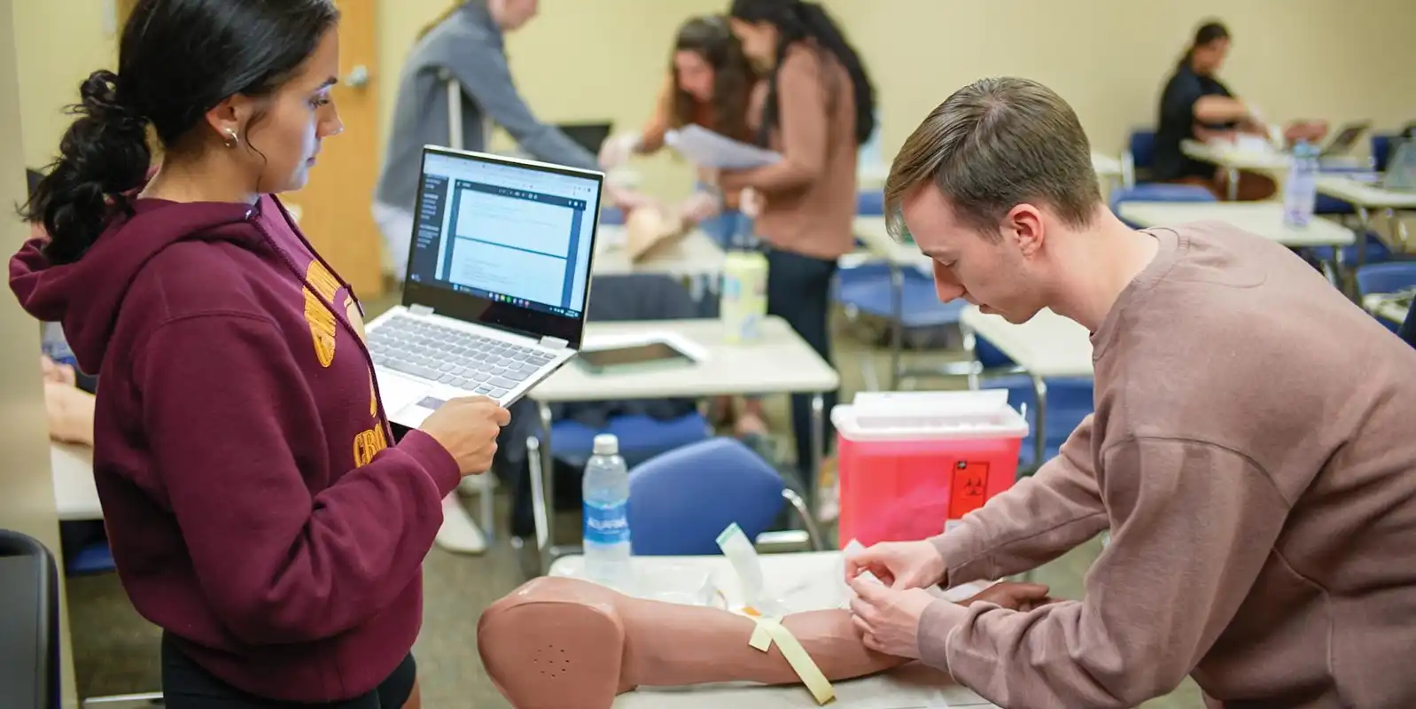 Physician assistant students in Erie Pennsylvania practicing clinical skills in a healthcare lab setting