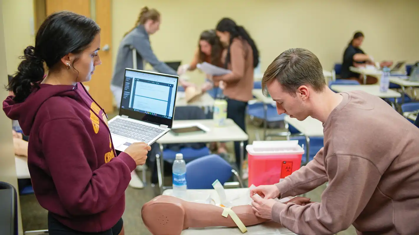 Physician assistant students in Erie Pennsylvania practicing clinical skills in a healthcare lab setting