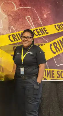 Headshot of Deandra Francis with Crime Scene tape behind her