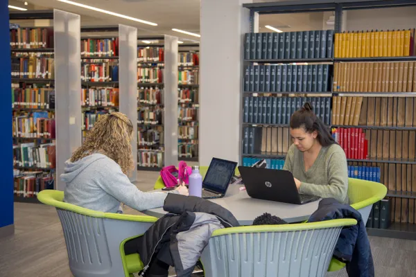 Two student studying at a table at Nash Library