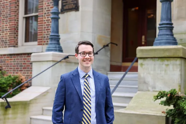 James Marsh smiles in front of a building in downtown Erie