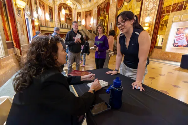 Lara Hope Schwartz signs her book after Gannon READS Lecture