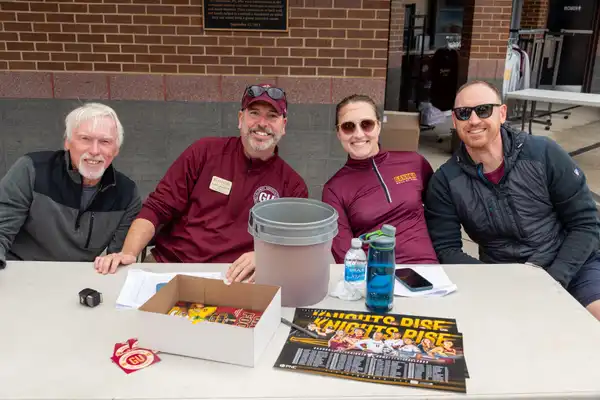 Alumni at a table during Homecoming