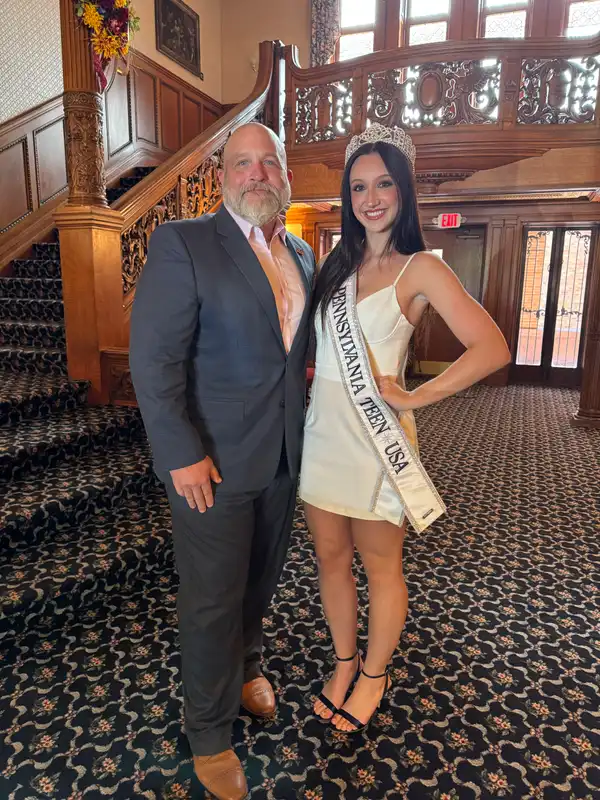 The Current Miss Pennsylvania Teen USA, Skylyn Goodenow (right), stands with Dr. Walter Iwanenko inside Old Main