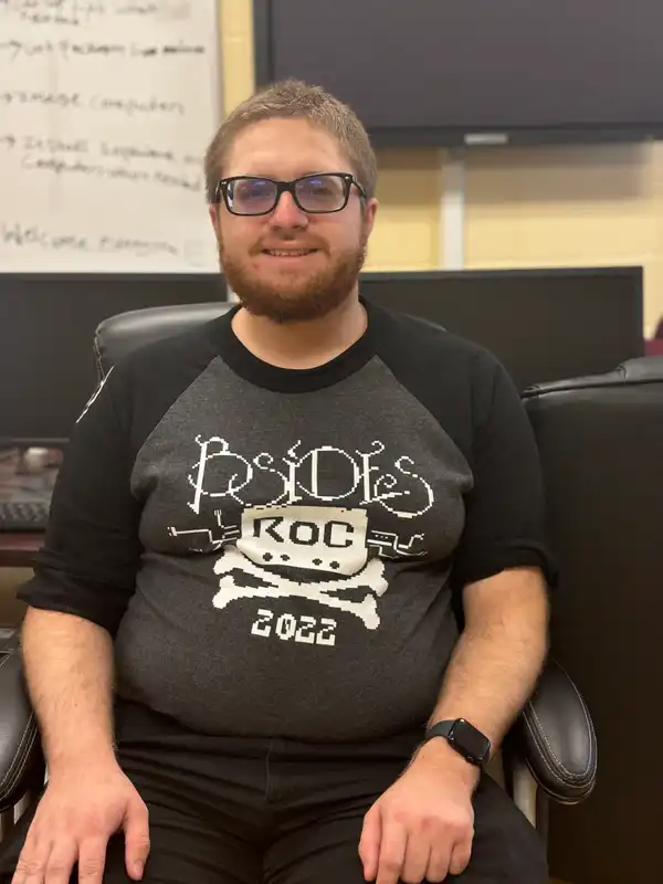 Hubbard sitting in a chair, smiling.
