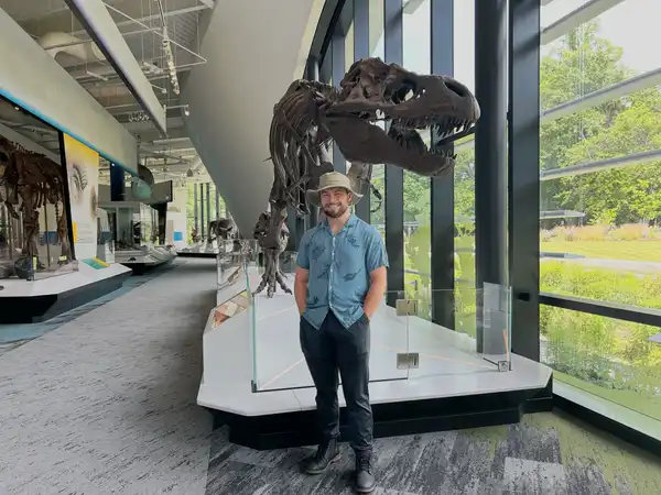 Anthony Sinito pictured in front of a dinosaur