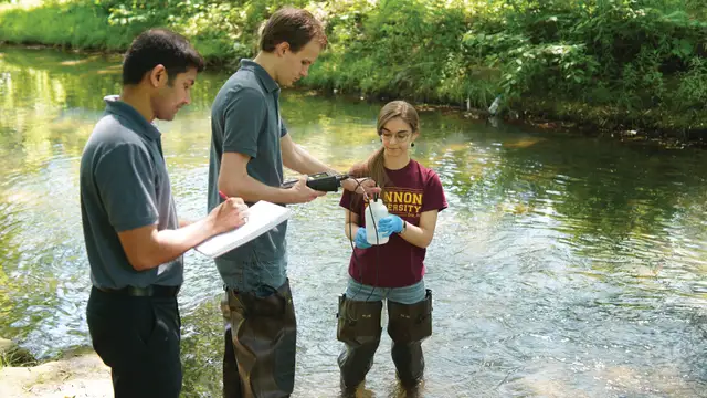 Students conducting Environmental Science research in a river.