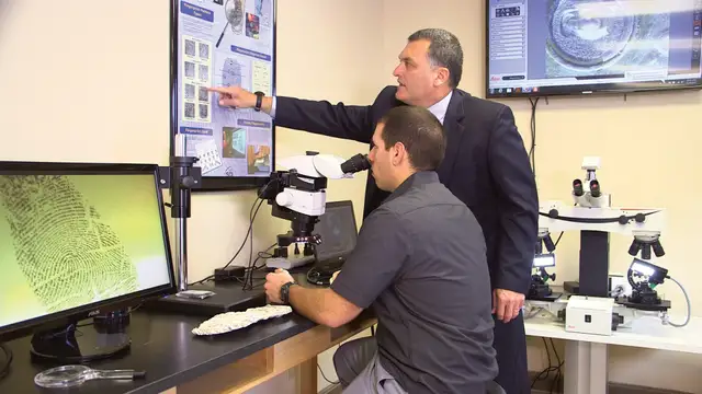 Student and faculty member reviewing fingerprints.