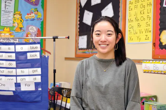 Education student inside an Elementary school classroom.