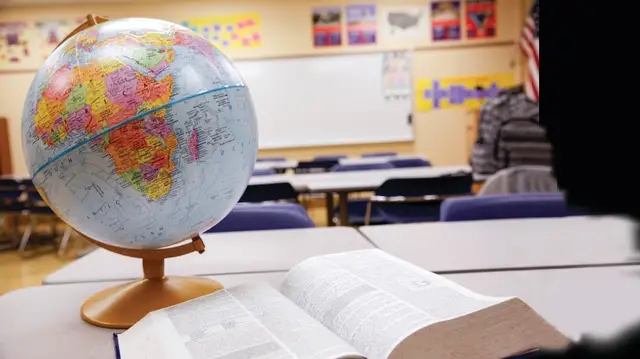 Globe and book in a classroom.