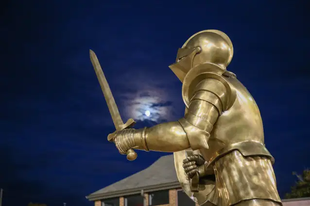 Gannon Knight statue at night.