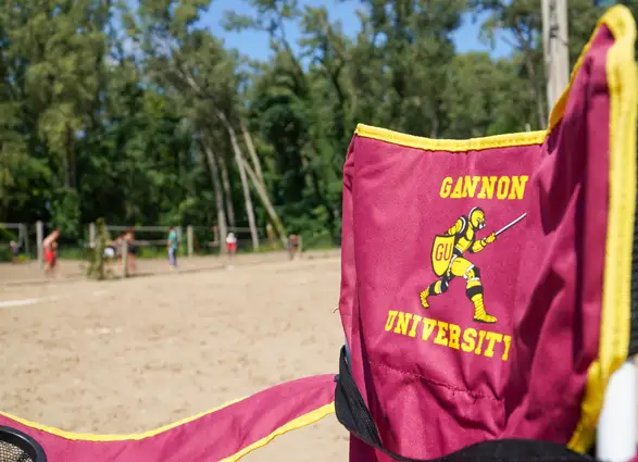 A maroon chair with the ˶ƽ Knight set up on the beach at Presque Isle