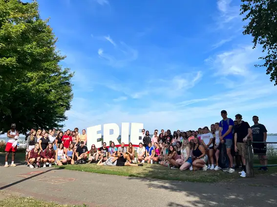 Students next to Erie sign
