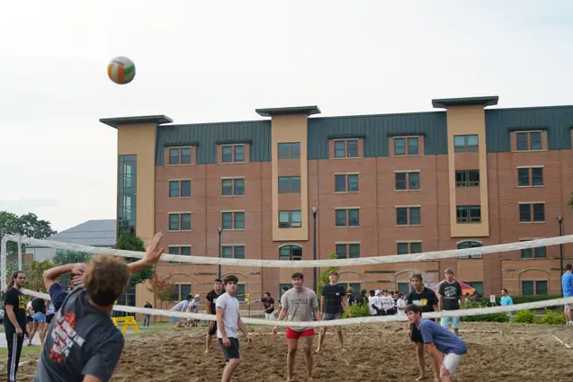 Students playing Volleyball by North Hall