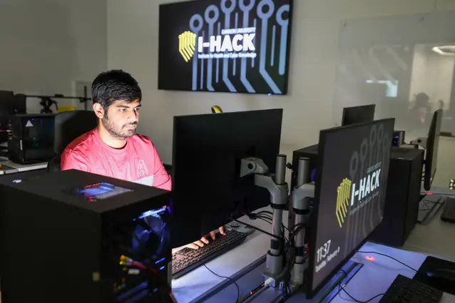 A student working on a computer in the I-Hack building.
