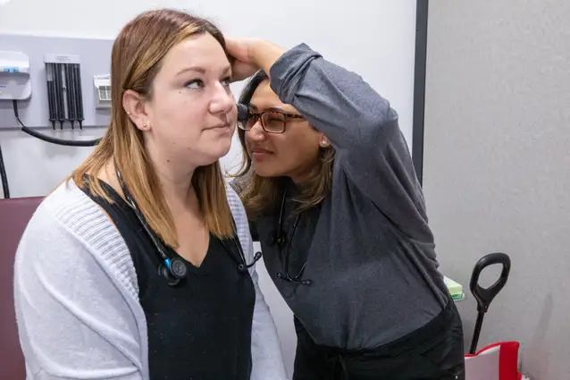 Ruskin PA student giving an ear exam