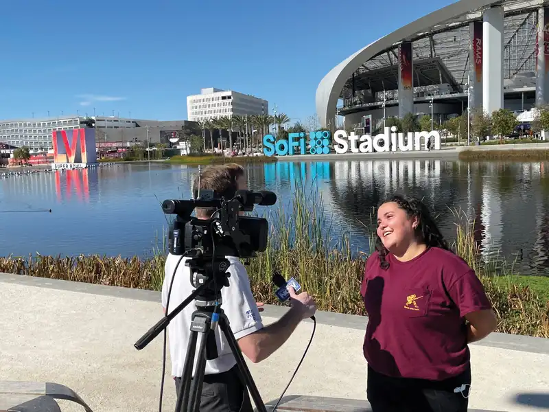 Students conducting interviews outside of sofi stadium for Super Bowl 56