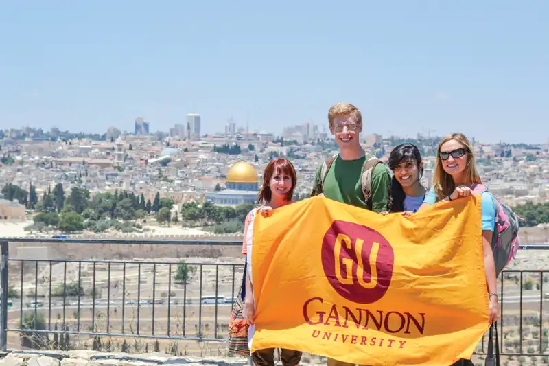Students holding a Gannon flag.