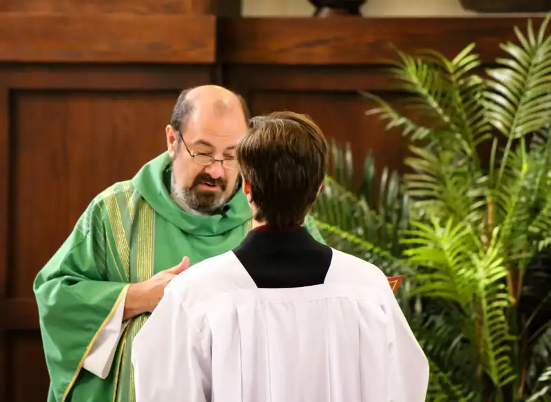 Father Kesicki reading with Alter Server