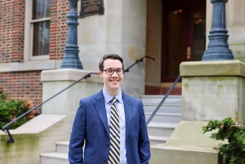 James Marsh smiles in front of a building in downtown Erie
