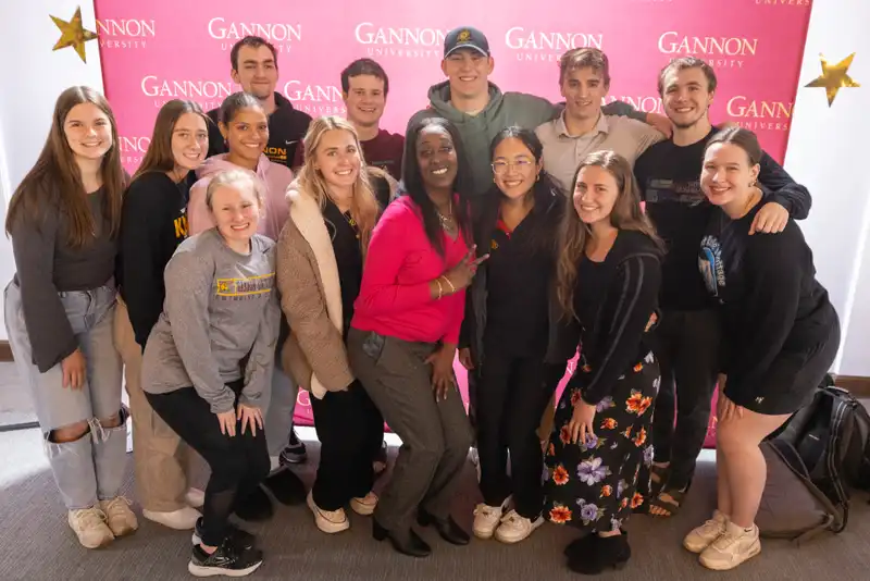 Students posing for a photo with awardee Chante Woodard