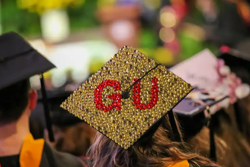 A graduation cap decorated to spell GU