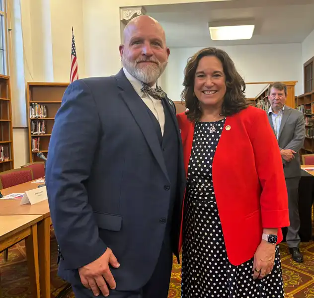Dr. Walter Iwanenko standing with Deputy Secretary of Education Cindy Marten