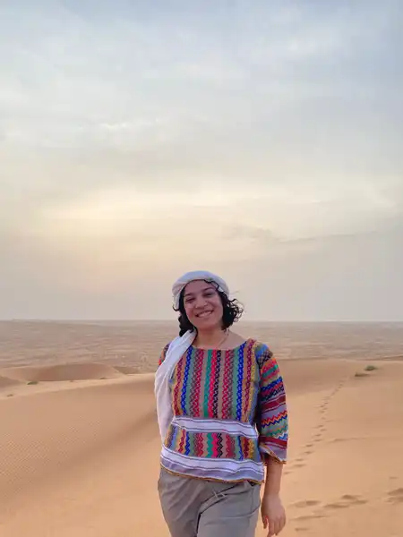 Claudia Herrero Rapagna stands in the Omani desert while on her second Critical Language Scholarship learning intensive in Niwaz, Oman