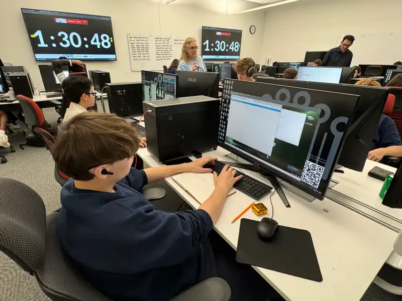 Students sit in the Cyber Attack Lab in 91's I-HACK practicing for the CyberPatriot Camp