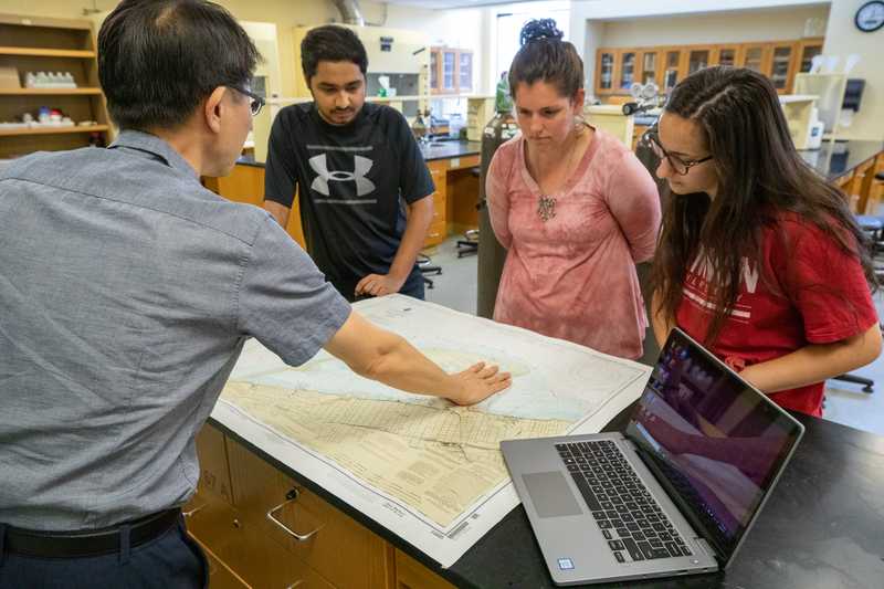 Student looking at a map in an Environmental Engineering lab.