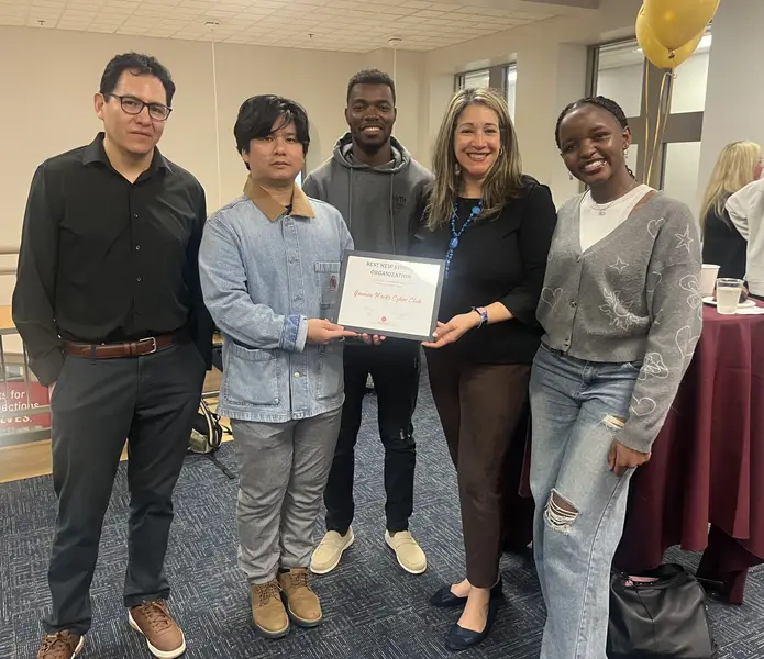 Cybersecruity students pose with faculty upon receiving the award for best new club for the creation of the cyber hacks club