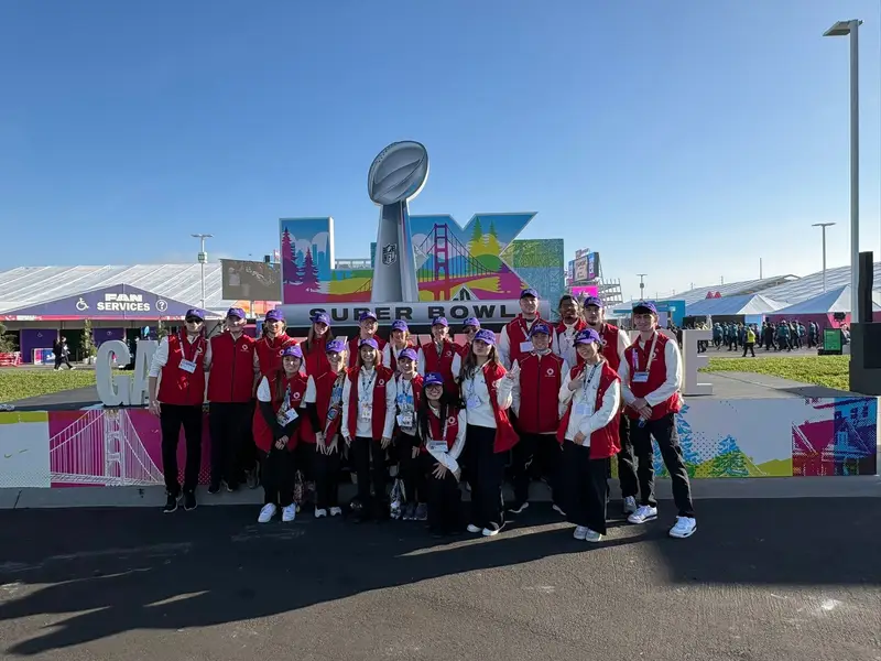 A group of ������Ƶ Students pose at the fan services station outside of the Super Bowl LX arena