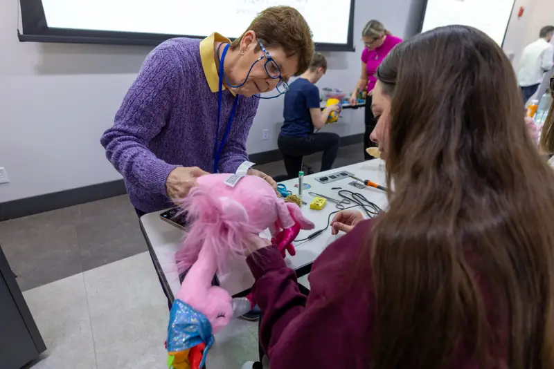 OTD students working with a professor to creative adaptive toys for children