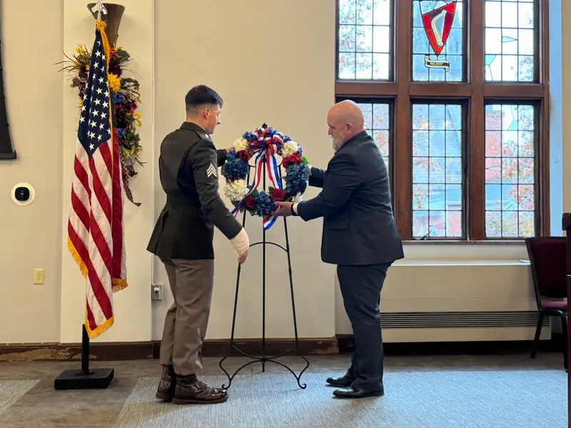 Dr. Walter Iwanenko and Sgt. Matthew Stenger together set up the wreath honoring Veterans.