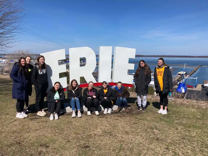 Students by the Erie Sign on the Bayfront